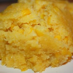 a piece of cornbread sitting on top of a white plate