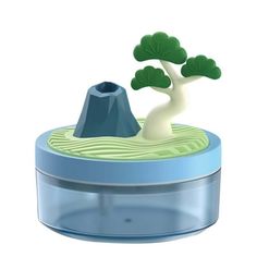 a small bonsai tree in a plastic container with blue base and green leaves on top