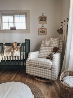 a baby's room with a rocking chair and teddy bear in the crib