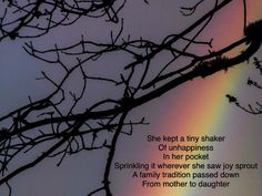 a rainbow shines in the sky behind some bare tree branches with a poem written on it