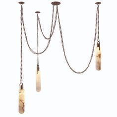 three lights with chains hanging from the ceiling