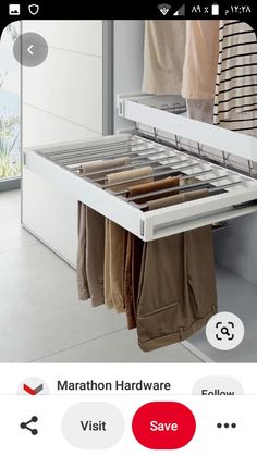 an open drawer with clothes hanging from it