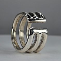 **Please note that we dispatch on Tuesdays unless special delivery express option is paid for** Sterling silver 'Open 3' ring. Original design carved in wax then lost wax cast into solid sterling silver. Hallmarked. This is a beautifully large and chunky ring, with thickness and weight to it. Weighs approximately 39 grams, it's a larger ring and may not suit delicate ring enthusiasts.  The joy of this ring lays in it's feel, it is smooth and heavy and glides on the finger reassuringly. You reall Modernist Hand Cast Sterling Silver Rings, Unique Silver Stackable Rings Hallmarked, Silver Hand Cast Stackable Rings For Anniversary, Silver Stackable Hand-cast Rings For Anniversary, Hand Cast Sterling Silver Stackable Rings, Knuckle Duster, Friendship Rings, Chunky Ring, Cat Ring