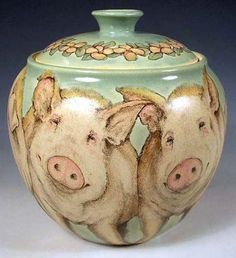 two pigs painted on the side of a vase