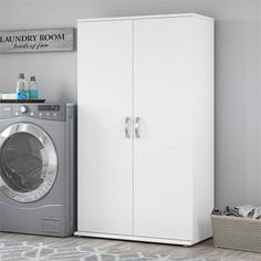 a laundry room with a washer and dryer sitting next to each other on the floor