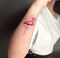 a woman with a pink flamingo tattoo on her arm