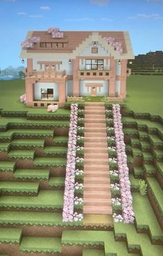 a large house sitting in the middle of a lush green field with lots of flowers