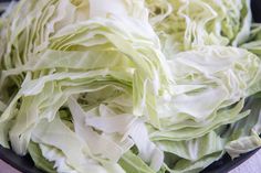 lettuce in a black bowl sitting on a table