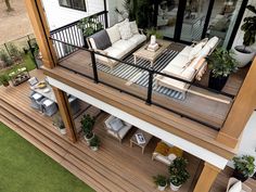 an aerial view of a deck with furniture and potted plants on the top floor