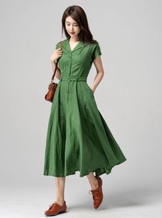 "This vintage-inspired short-sleeved shirt dress is the perfect addition to any retro lover's wardrobe! Featuring a classic collared neckline, front button closure, and a flattering A-line silhouette, this dress is both timeless and trendy. The lovely shade of green is sure to turn heads and the lightweight fabric makes it perfect for warmer weather. DETAILS * 50% linen, 50% cotton * Two side pockets * Front Button up closure * Belted dress * Short sleeve * Notched collar * Below knee Length * P A-line Dress Casual, Elegant Summer Vintage Fashion Midi Dress, Fitted Short Sleeve Casual Vintage Dress, Casual Fitted Short Sleeve Vintage Dress, Elegant Summer Midi Dress For Vintage Fashion, Casual Fitted Vintage Dress With Short Sleeves, Solid Color Short Sleeve Midi Dress With Button Closure, Knee-length Solid Color Vintage Summer Dress, Green Vintage A-line Midi Dress