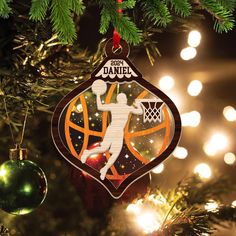 an ornament hanging from a christmas tree in the shape of a basketball player