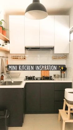 a kitchen with white cabinets and black counters