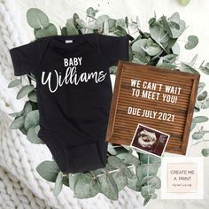 a baby bodysuit with the words, we can't wait to meet you due july