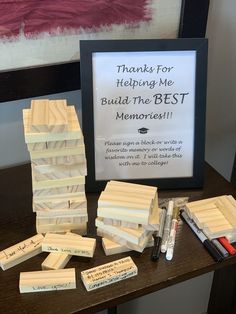 a wooden block with writing on it and some marker pens next to it that says thanks for helping me build the best memory