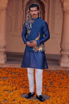 Blue chanderi bundi with placement abstract pattern and contrast metallic sequin embroidery. Paired with full sleeve kurta and contrast straight pyjama. - Aza Fashions Blue Bandhgala With Mirror Work For Festive Occasions, Designer Blue Sherwani With Gota Work, Designer Bandhgala With Gold Embroidery In Chanderi, Blue Chanderi Nehru Jacket For Designer Wear, Blue Bollywood Sherwani With Gota Work, Blue Kurta With Gold Embroidery For Diwali, Festive Chanderi Bandhgala With Gold Embroidery, Festive Bandhgala With Gold Embroidery Chanderi, Blue Sherwani With Gota Work For Festivals