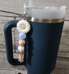 a coffee mug with a keychain attached to it