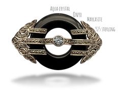 This is a old stunning Vintage Art Deco Design, Sterling Silver, Black Onyx, Aqua crystal  And Marcasites Brooch/Pin.  impressive deco-ispired, this brooch has an elongated shape with a 35mm circle in  black onyx,  is embedded in a magnificent Deco frame, covered by small marcasites, set on a 925 solid sterling setting  In the center of black ring stand a Aqua crystal bezel set with open back No missing Marcasites, not even a one! A classic and gorgeous design is here in this fabulous brooch!  " Collectible Round Gemstone Brooch, Collectible Round Gemstone Brooches, Luxury Round Brooches For Collectors, Luxury Round Collectible Brooches, Luxury Sterling Silver Brooches, Art Deco Oval Brooch Jewelry, Luxury Silver Oval Brooches, Art Deco Oval Brooch, Art Deco Round Brooch Jewelry