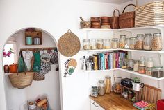 the shelves are filled with many different types of baskets and other things to put on them