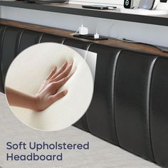 a person's hand on top of a headboard in front of a computer desk