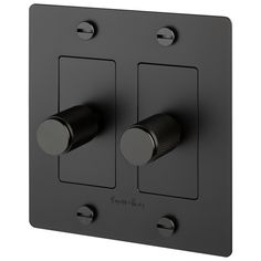 two black knobs on the side of a gray wall plate with one light switch