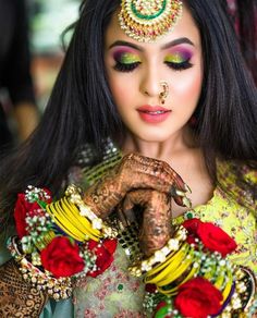 a woman with makeup and jewelry on her hands