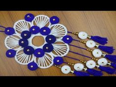 some white and blue tassels on a wooden table