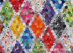 the colorful quilt is made up of many different types of flowers and shapes, including hexagonals