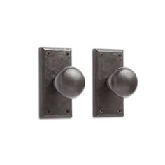 two metal door knobs on a white background