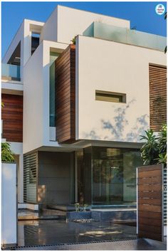 a white house with wooden slats on the front and side walls, in an urban area