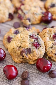 cookies with cherries and chocolate chips on a wooden surface