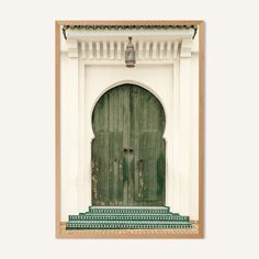 a green door and steps in front of a white building with an arched wooden door