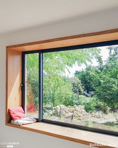 the window is open to let in some natural light and see the trees outside it