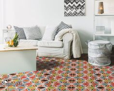 a living room filled with white furniture and lots of colorful rugs on the floor