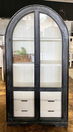 a black and white display cabinet with glass doors