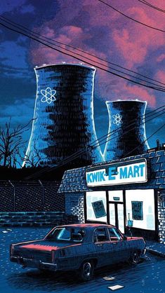 two cars parked in front of a building with cooling towers