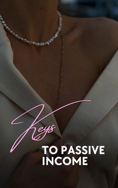 a close up of a person wearing a necklace with the words keys to passive income