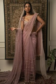 a woman in a pink sari and veil