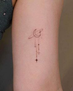 a small crescent and star tattoo on the left side of the arm, which is attached to