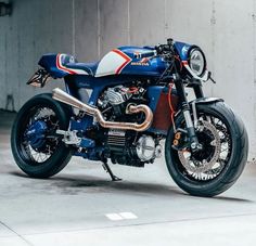 a blue and white motorcycle parked in a garage