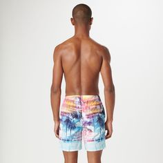 The Cosmo swim trunks are crafted from premium comfort stretch polyester in a tropical photoprint and feature an elastic waist with adjustable drawstring, a breathable stretch mesh lining, drainage grommets, side pockets, a rear patch flap pocket, UV protection and quick-dry technology. The sleek 17.5-inch out seam, offers the perfect balance between coverage and freedom of movement, making it an ideal choice for the beach or relaxing by the pool. Multicolor Swimwear With Built-in Shorts For Vacation, Printed Swim Trunks For Poolside Vacation, Vacation Swim Trunks Printed For Poolside, Tropical Multicolor Shorts For Pool, Tropical Multicolor Swim Trunks For Vacation, Tropical Print Swim Trunks For Pool And Beach Season, Beachwear Swim Trunks With Tropical Print For Poolside, Multicolor Swim Trunks For Poolside Vacation, Printed Swim Trunks For Vacation