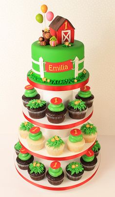 a three tiered cake with cupcakes on the bottom and green frosting