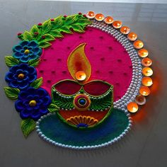 a decorated diya with lit candles and flowers on it's face is displayed