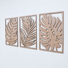 three wooden cut outs with leaves on them