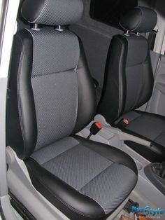 the interior of a car with black leather seats and gray cloth upholsters