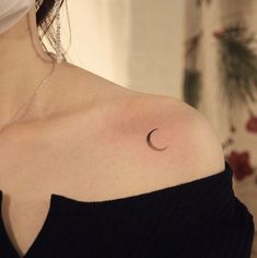 a woman with a crescent tattoo on her shoulder