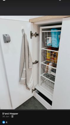 an open refrigerator door with some items in the freezer and hanging from it's side