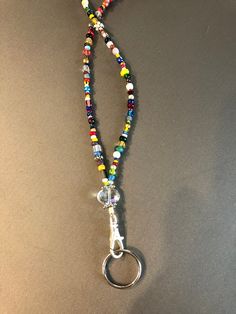 This multi-colored lanyard is beautiful as well as functional.  It is 18" long from the top to the silver ring.  This is a one-of-a-kind item which includes crystals, silver and glass beads. Cheap Multicolor Beaded Lanyards, Multicolor Bohemian Jewelry For Everyday Use, Multicolor Bohemian Jewelry For Everyday, Multicolor Beaded Jewelry For Everyday Use, Multicolor Beaded Necklace With Lobster Clasp For Everyday Use, Multicolor Beaded Necklaces With Round Beads For Everyday, Multicolor Round Beaded Necklaces For Everyday, Unique Multicolor Jewelry For Everyday Use, Silver Beaded Jewelry For Everyday