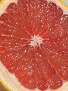 a grapefruit cut in half on a cutting board