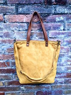 Tote suede leather bag in MUSTARD YELLOW. Natural genuine suede leather. Yellow large boho bag. Closed by a zipper, with shoulder straps and removable cross body adjustable straps. The inside of the bag is fully lined in a cotton/nylon strong fabric. We added a small leather pouch on the inner part of the bag and a zipper clised pocket aswell. You can easily carry your books, laptop or tablet in one nice bag , made of soft suede leather Width upper part: 42 cm - 16 inch Height: 38 cm - 15 inch b Suede Lining Satchel For Daily Use, Suede Hobo Tote Bag For Everyday Use, Daily Use Suede Satchel With Suede Lining, Suede Tote Satchel With Soft Leather, Suede Satchel Tote In Soft Leather, Daily Suede Satchel With Soft Leather, Daily Use Suede Satchel With Soft Leather, Soft Suede Leather Tote Satchel, Suede Satchel Shoulder Bag With Leather Handles