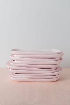 pink plates stacked on top of each other